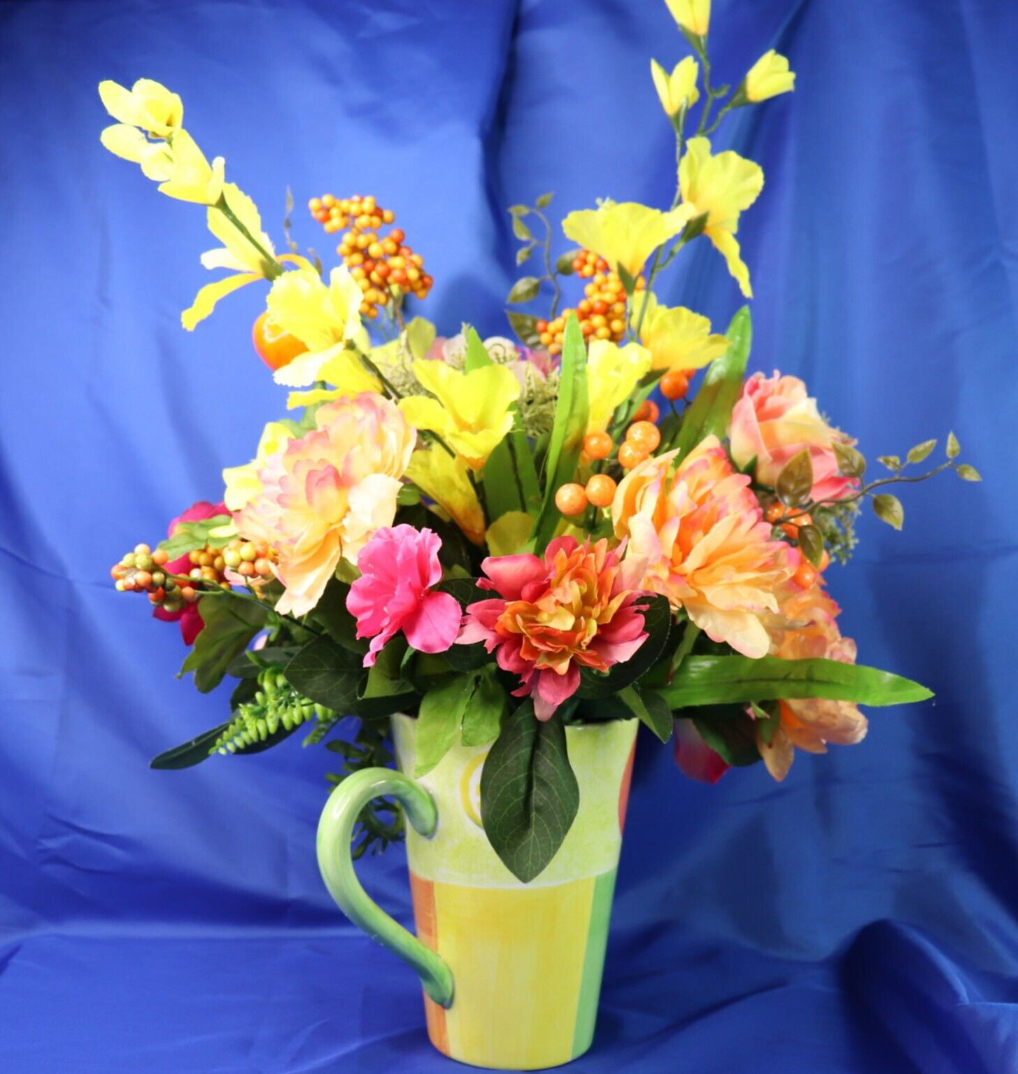 Very Colorful Floral Arrangement In A Beautiful Pitcher With Limes & Oranges
