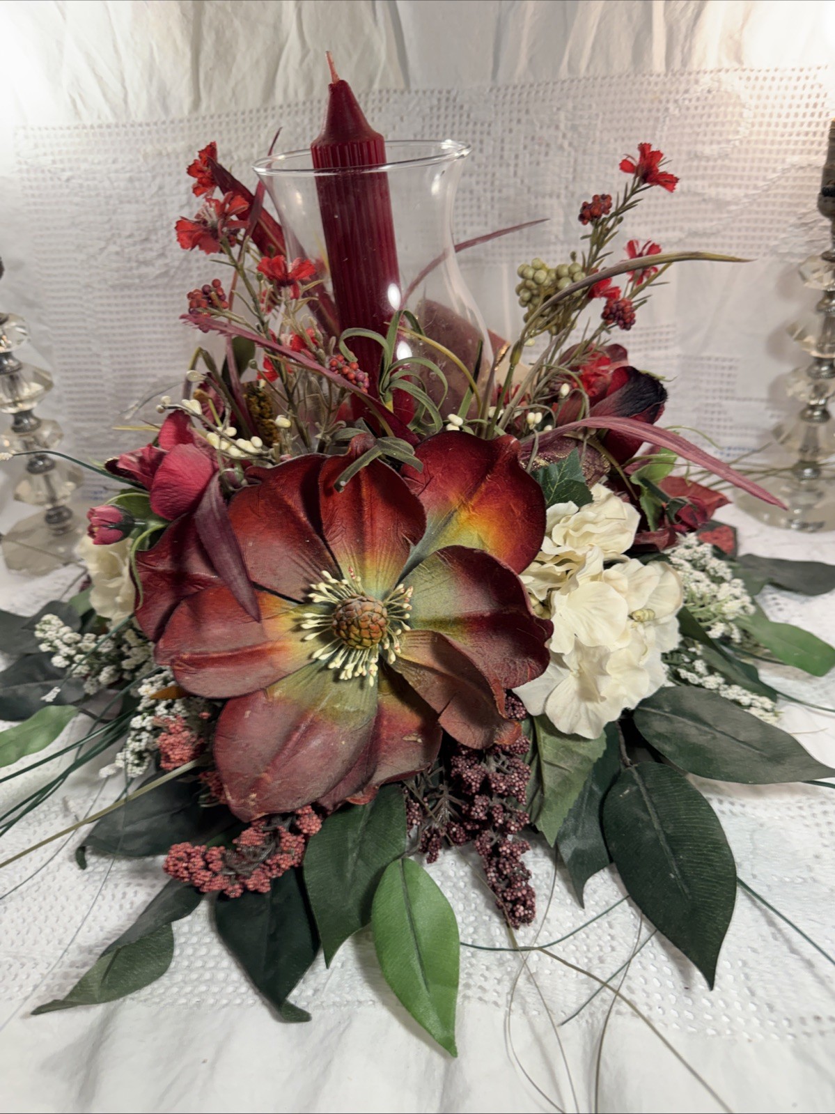 Artificial Fall Themed Floral Centerpiece Surrounding A Glass Vase