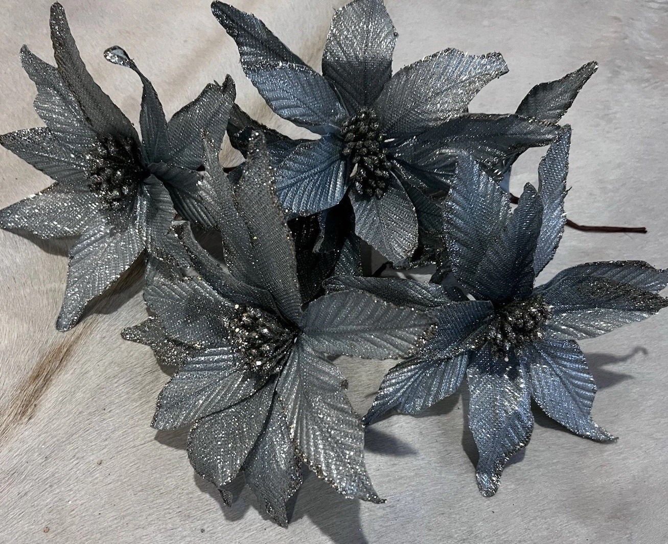 poinsettia flowers in a metallic Blue & silver used as decorations for Christmas