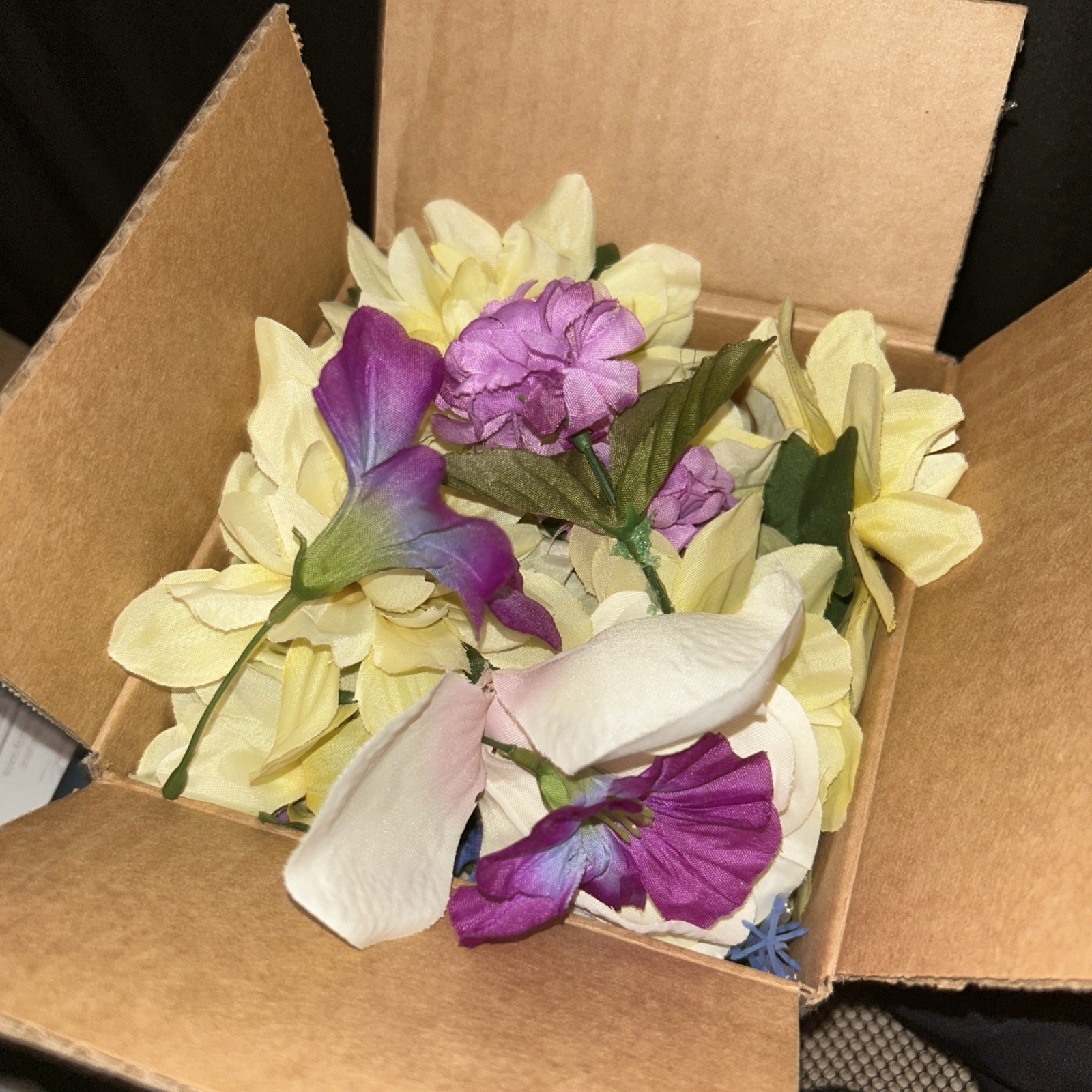 Box Full Of Fake Flowers Purple Blue And White Off White With Stems And Green