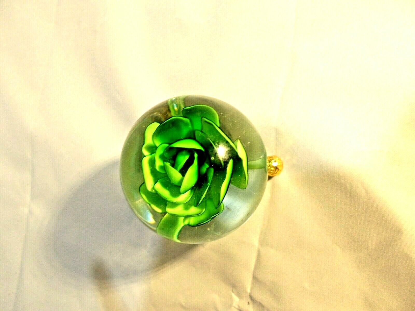 Green flower in glass on gold stand home – office decor, 3″ tall X 4″