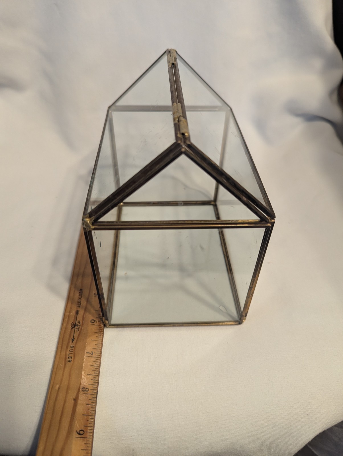 Small house shaped metal and glass terrarium