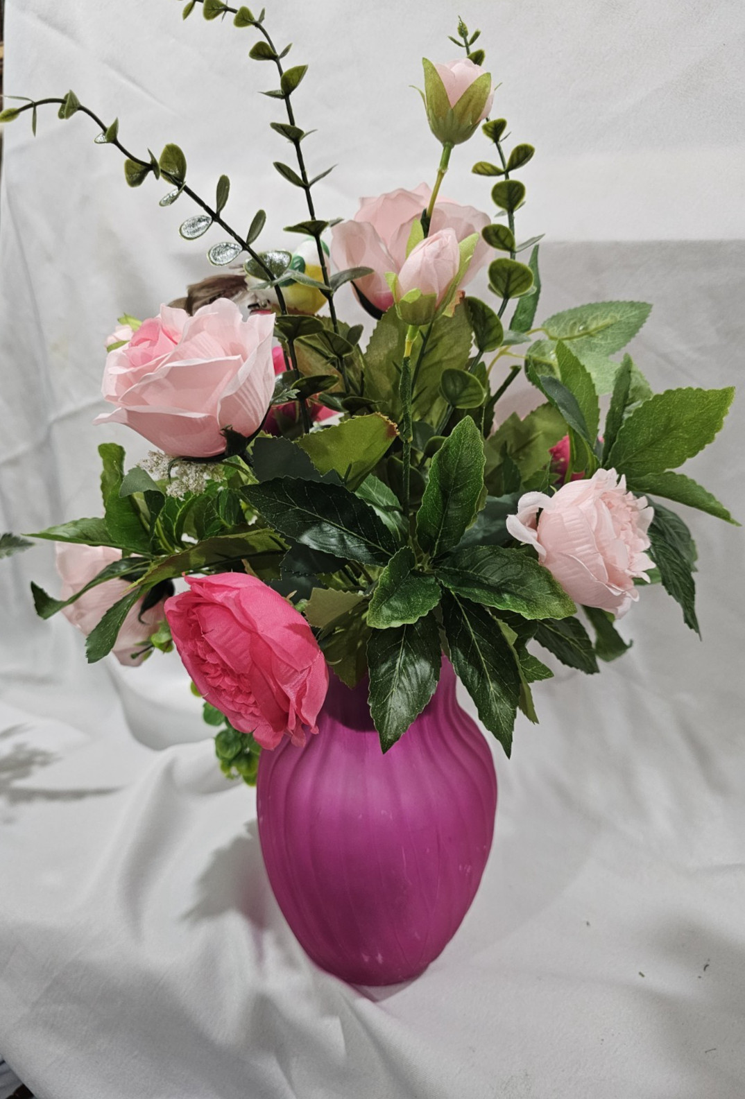 Varied Colors of soft Pink Artificial Roses in a beautiful pink vase