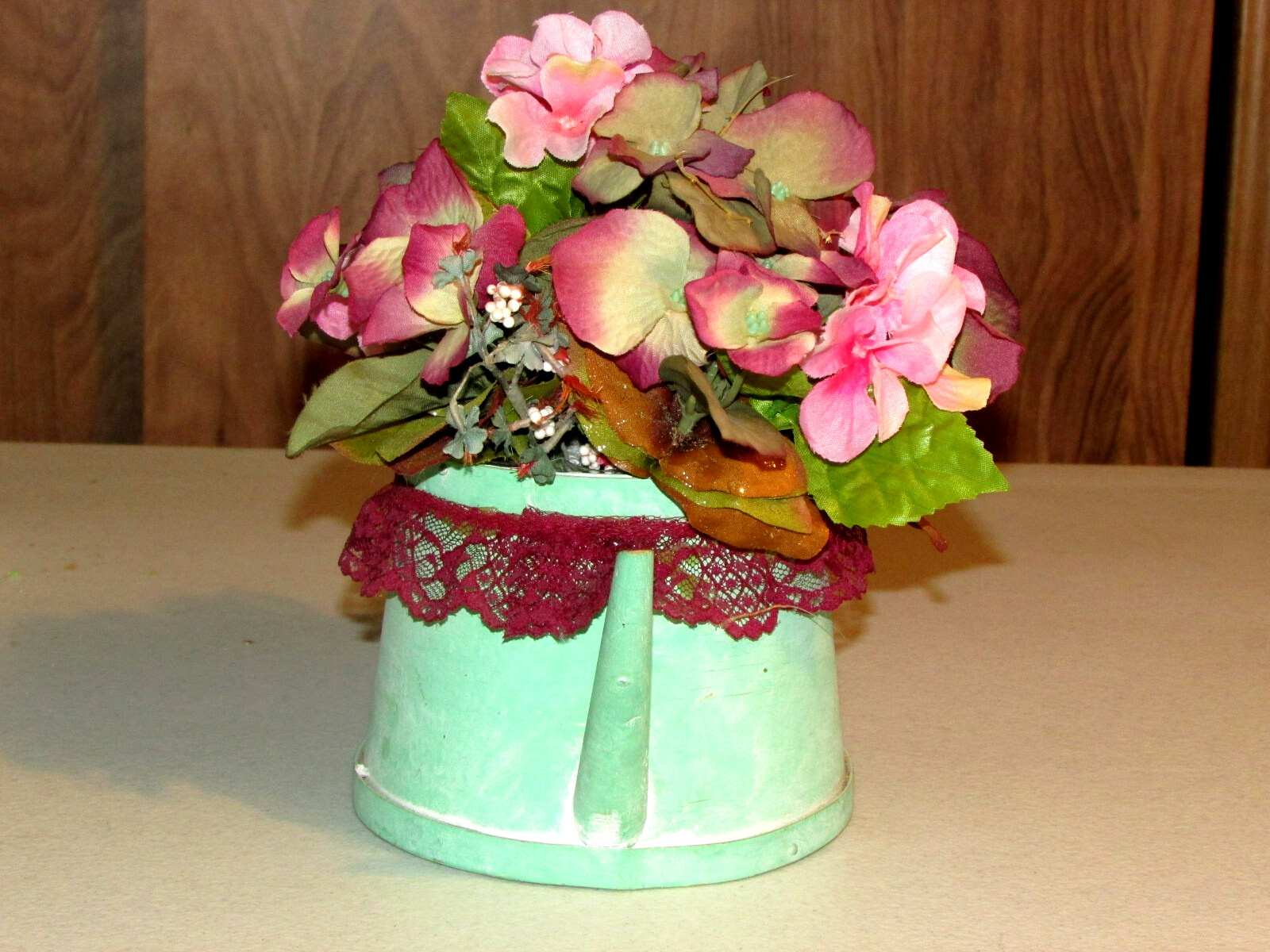 green cardboard WATER PAIL w/artificial FLOWERS 9x6x10″ overall (bdrm)