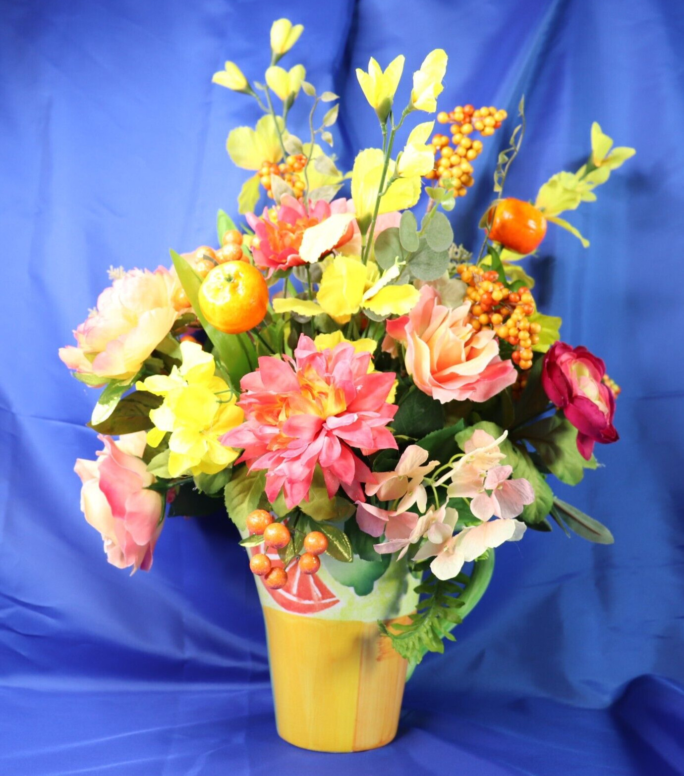 Very Colorful Floral Arrangement In A Beautiful Pitcher With Limes & Oranges