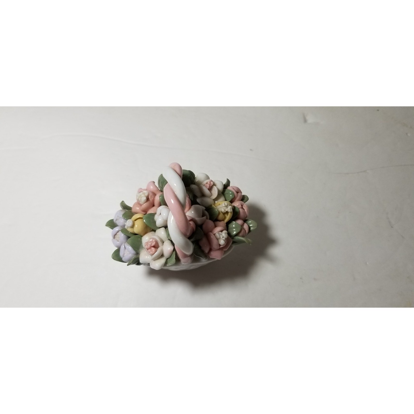 Three inch by 3 inch hand painted porcelain basket (1.1282)