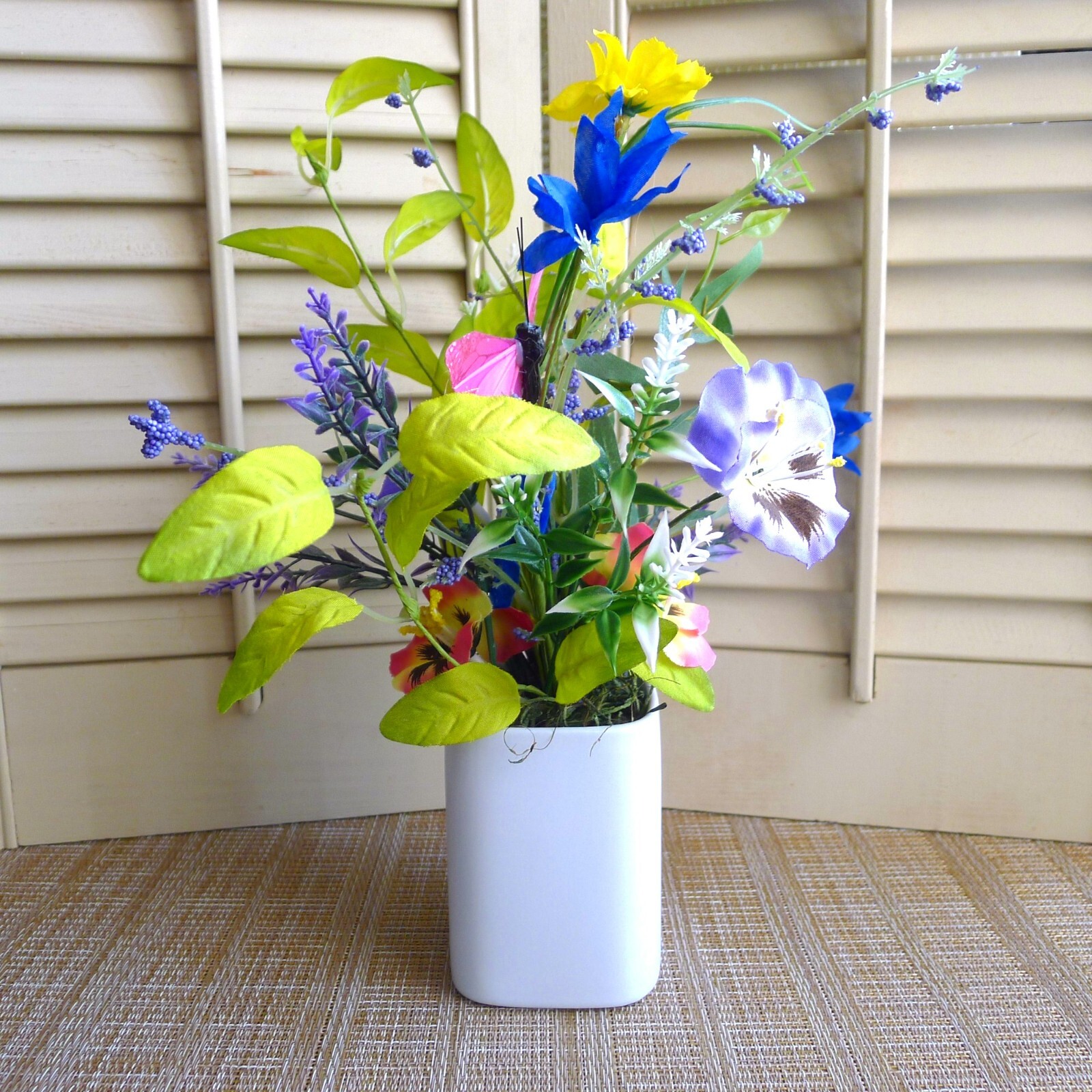 Wildflower Pansy Floral Arrangement Pink Feather Butterfly and a White Planter