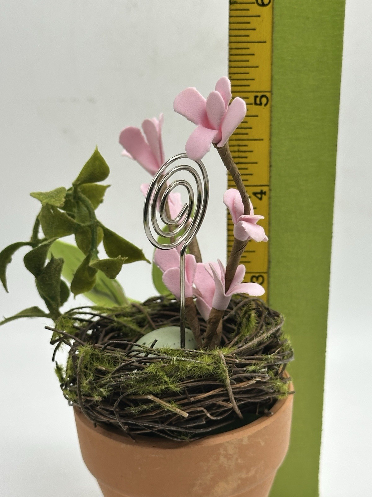 Photo Holder In Spring Themed Pot With Birds Nest Egg Flowers And Foliage