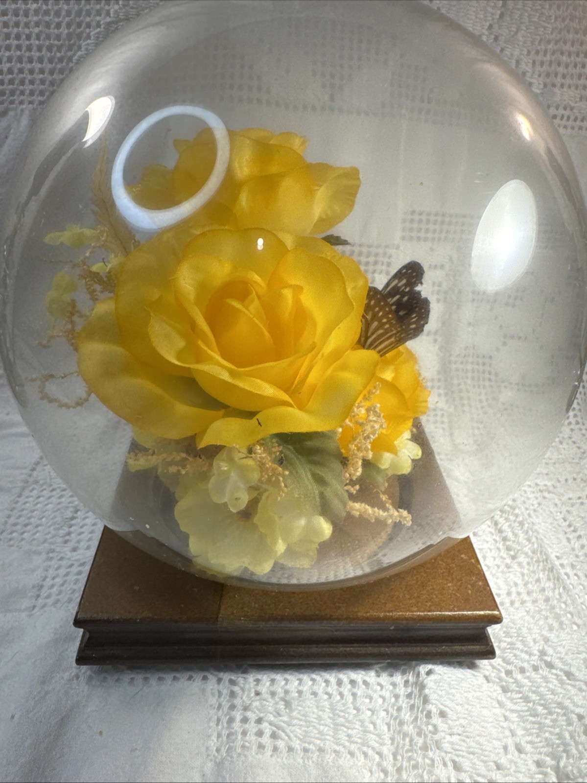 Vintage preserved flower arrangement in glass dome