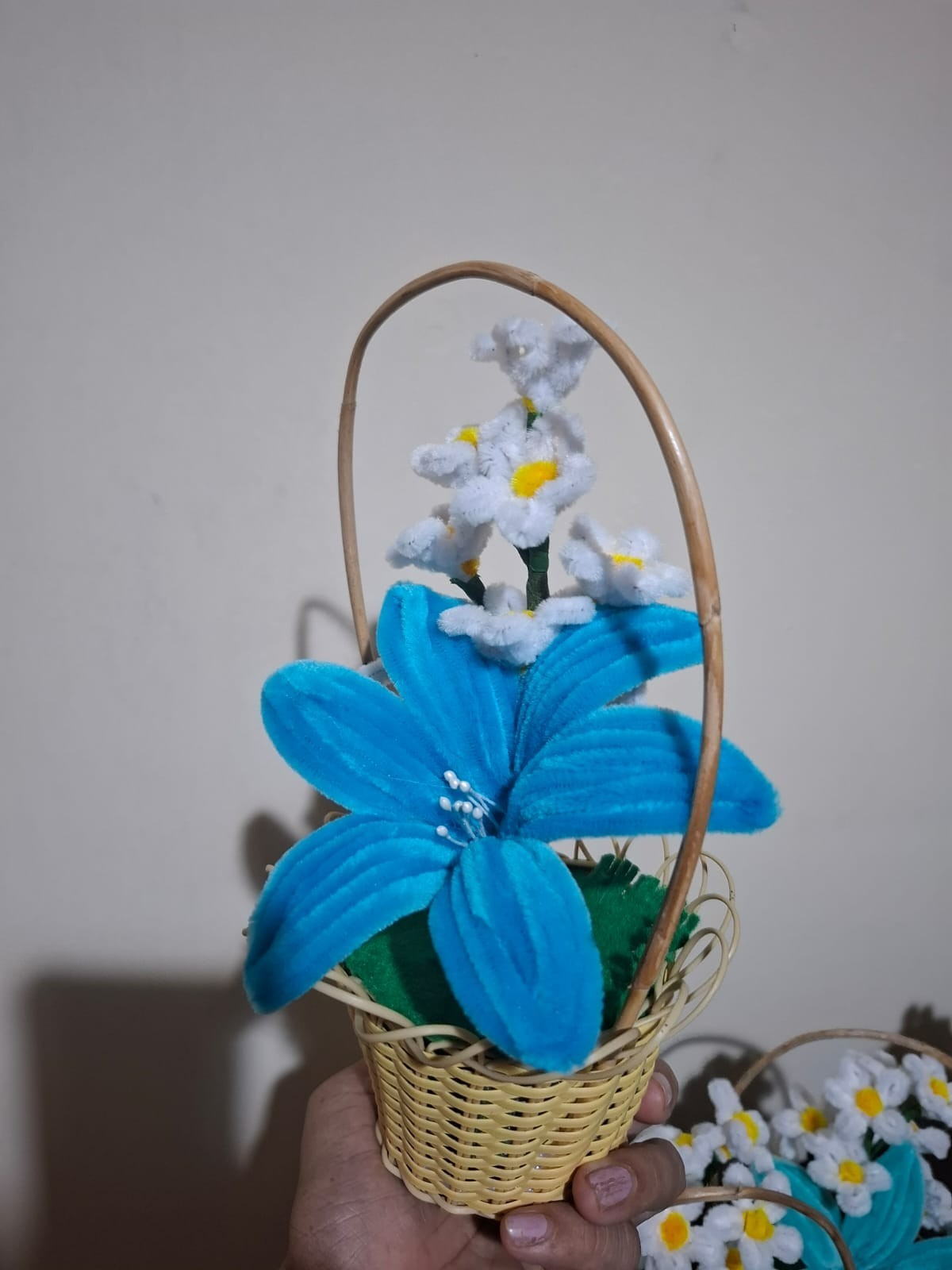 pipe cleaner blue lily flower in a cane basket
