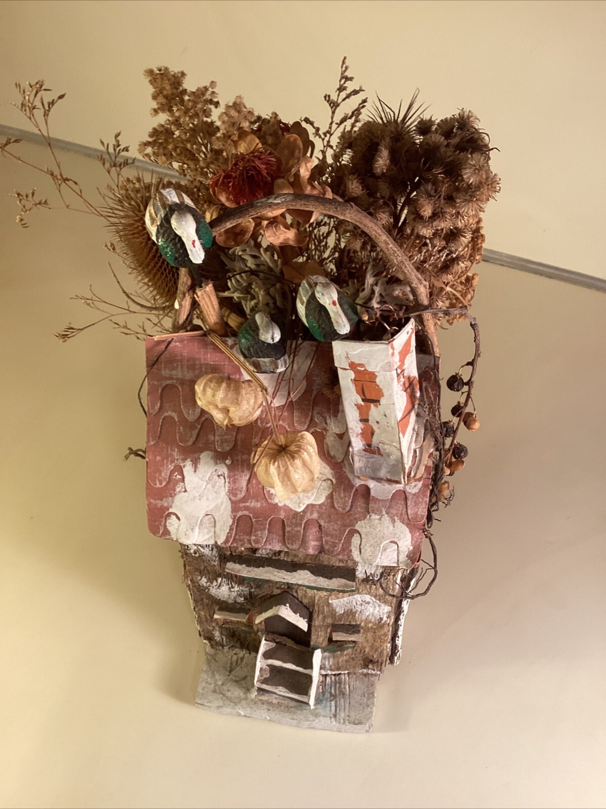 Wood birdhouse centerpiece with dried flowers, turkeys, twigs, windows, chimney