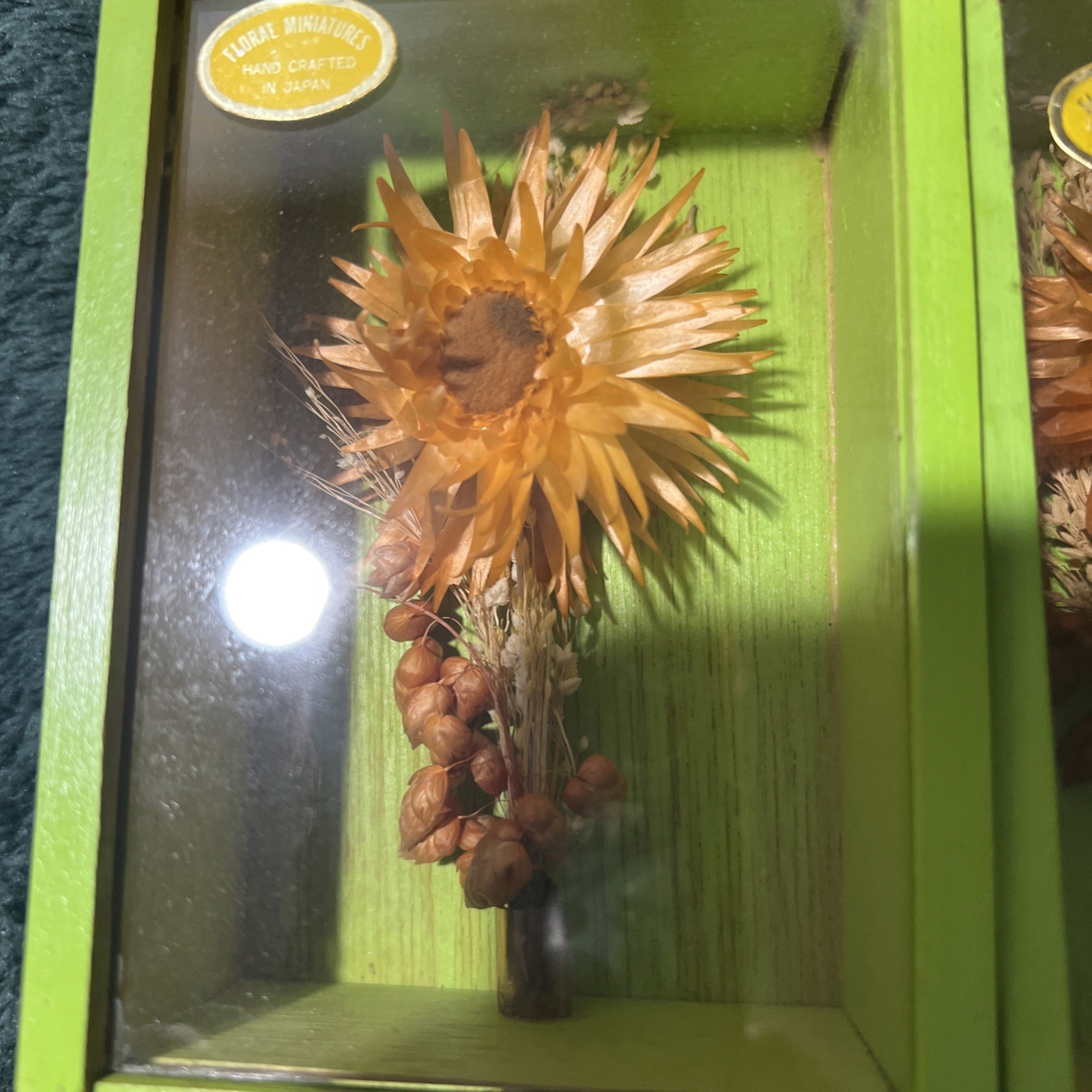 Two Modern Decorative Boxes Containing Dried Orange Flowers and Seed Pods. New