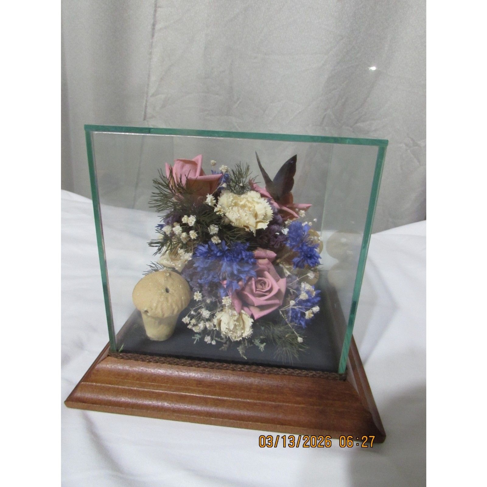 Vintage dried flower arrangement in glass with wood base butterfly mushrooms