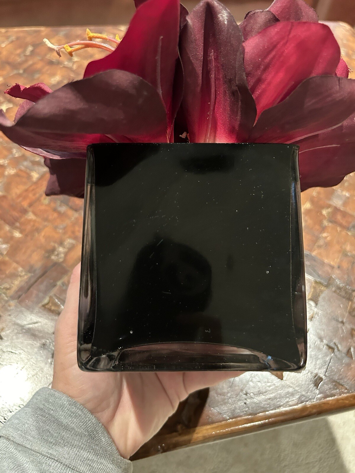 Artificial Amaryllis in Black Glass Vase