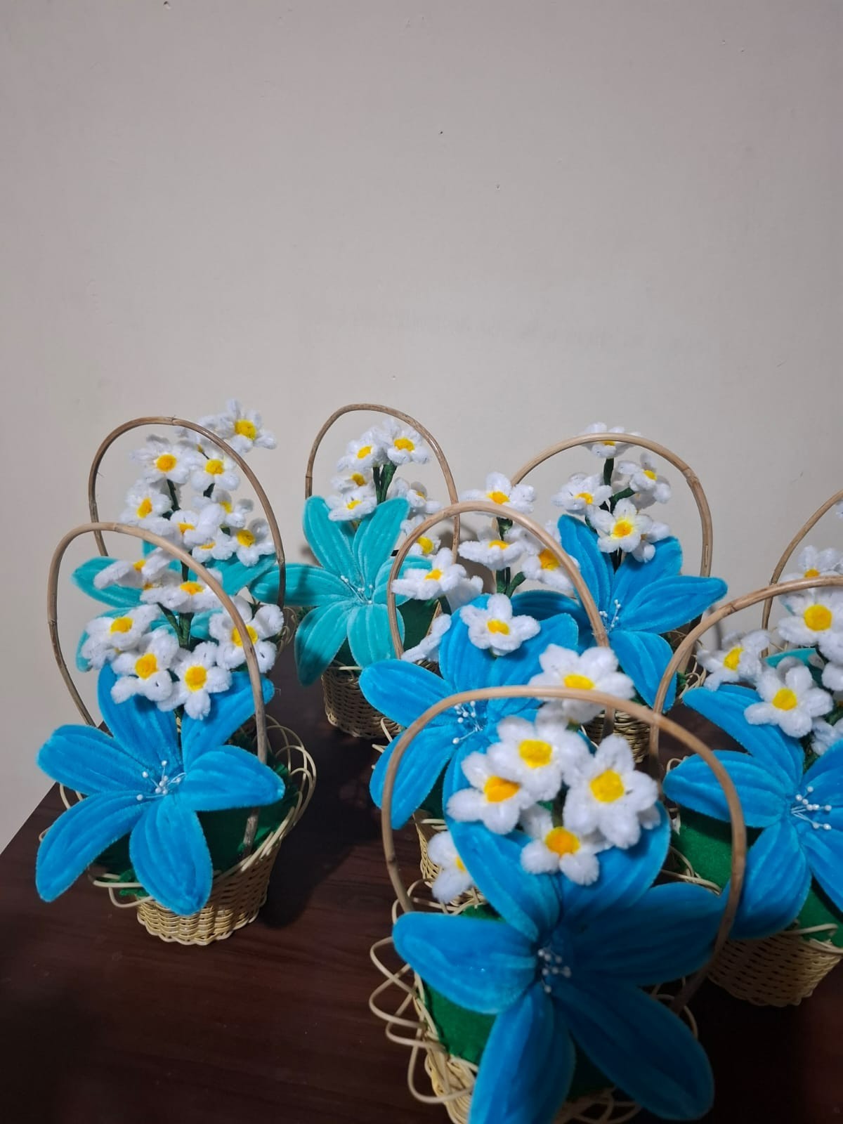 pipe cleaner blue lily flower in a cane basket