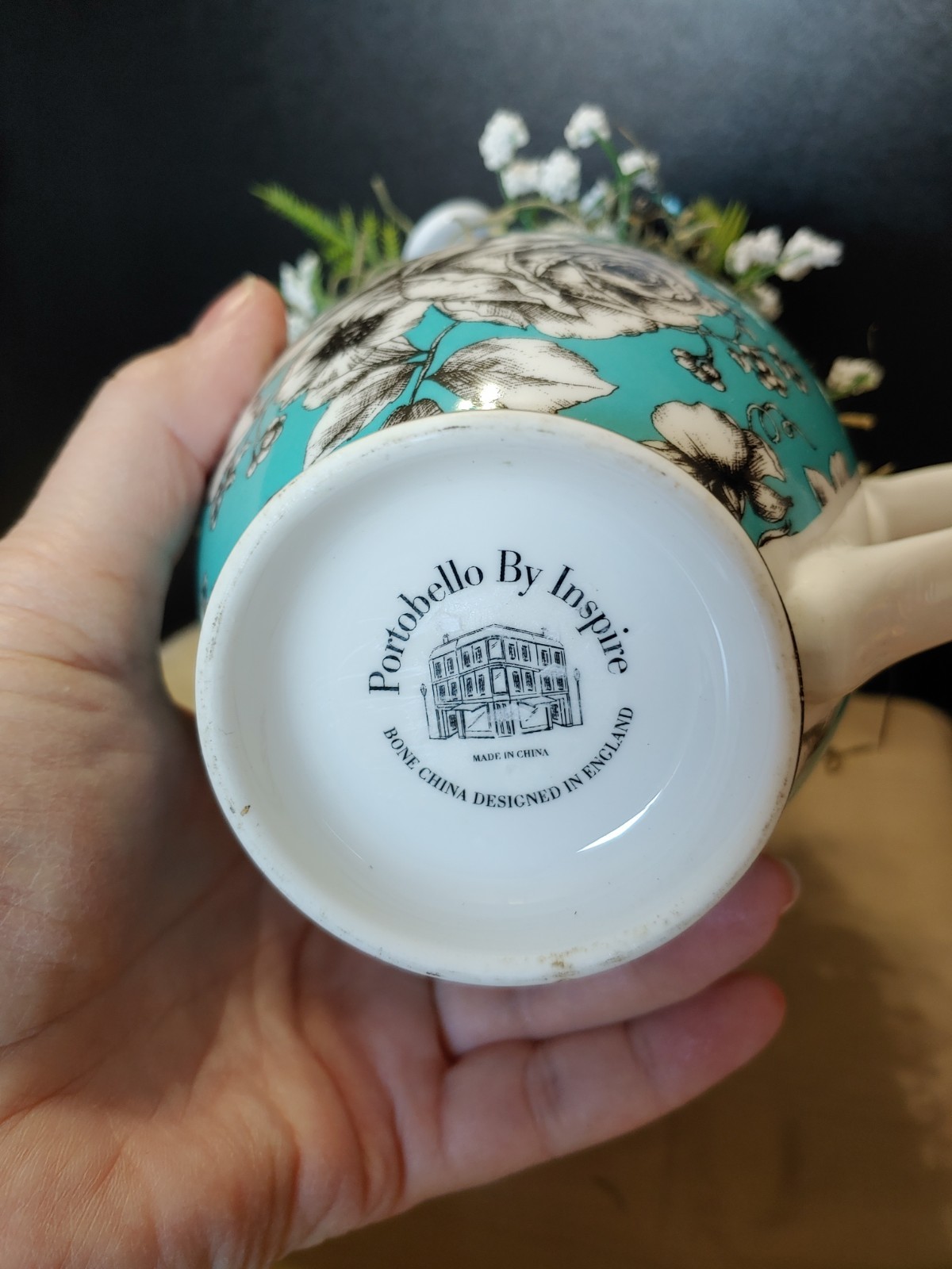 BUTTON BOUQUET IN matching turquoise, black, and white floral mug.