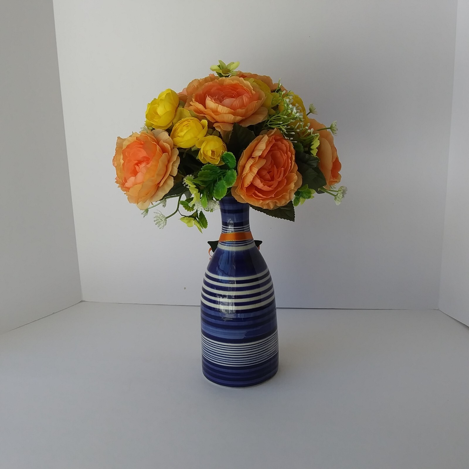 Blue White Striped Pottery Vase with Peach and Yellow Rose Floral Arrangement