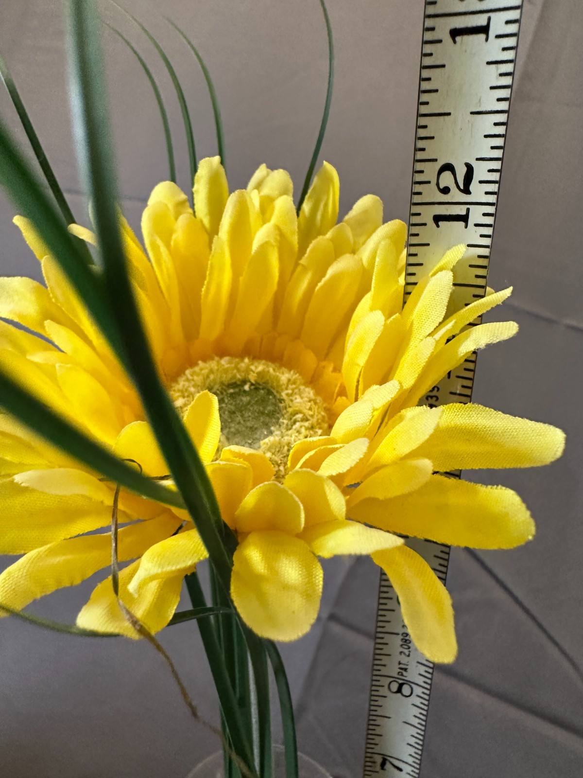 Faux Yellow Gerbera Daisy arrangement in a clear glass cylinder vase
