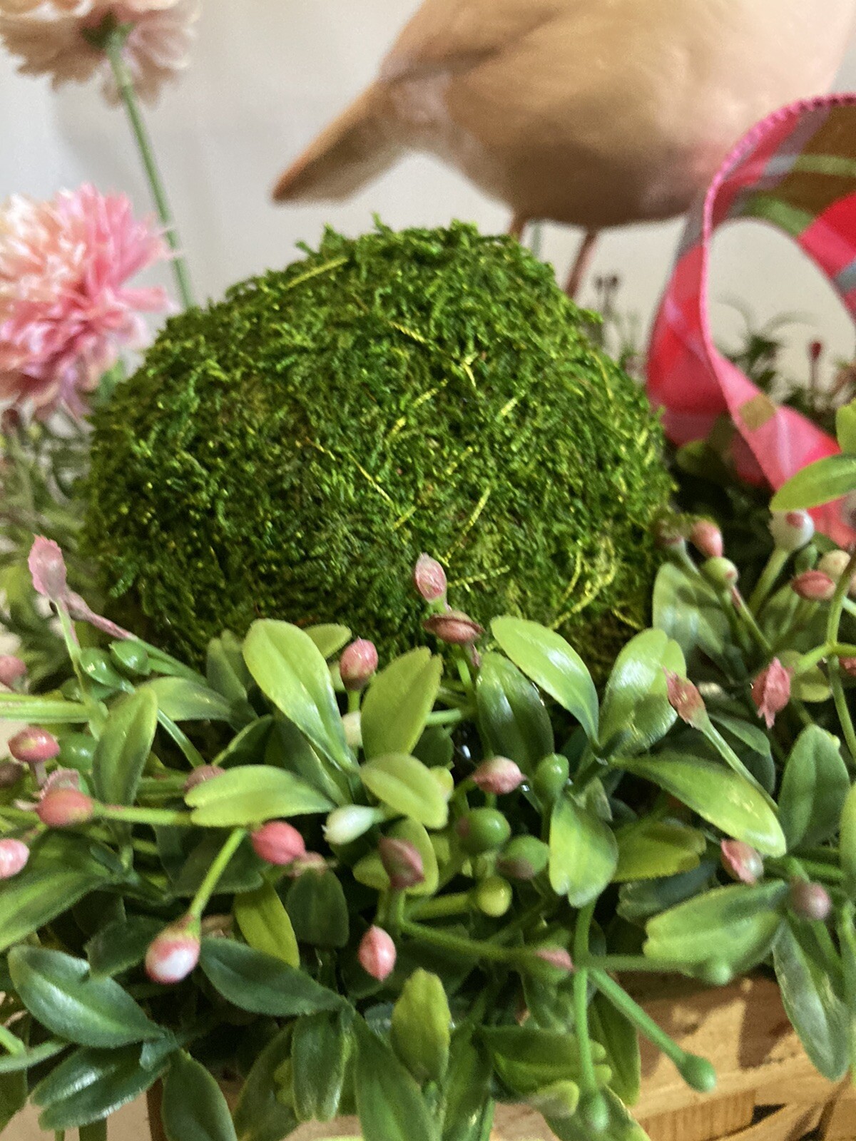 Delightful Pink Bird Surrounded In Boxwood Greenery In A Basket