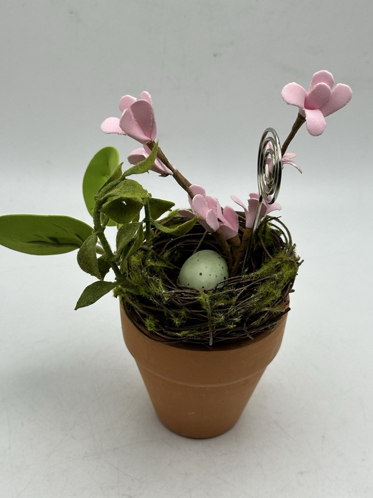 Photo Holder In Spring Themed Pot With Birds Nest Egg Flowers And Foliage
