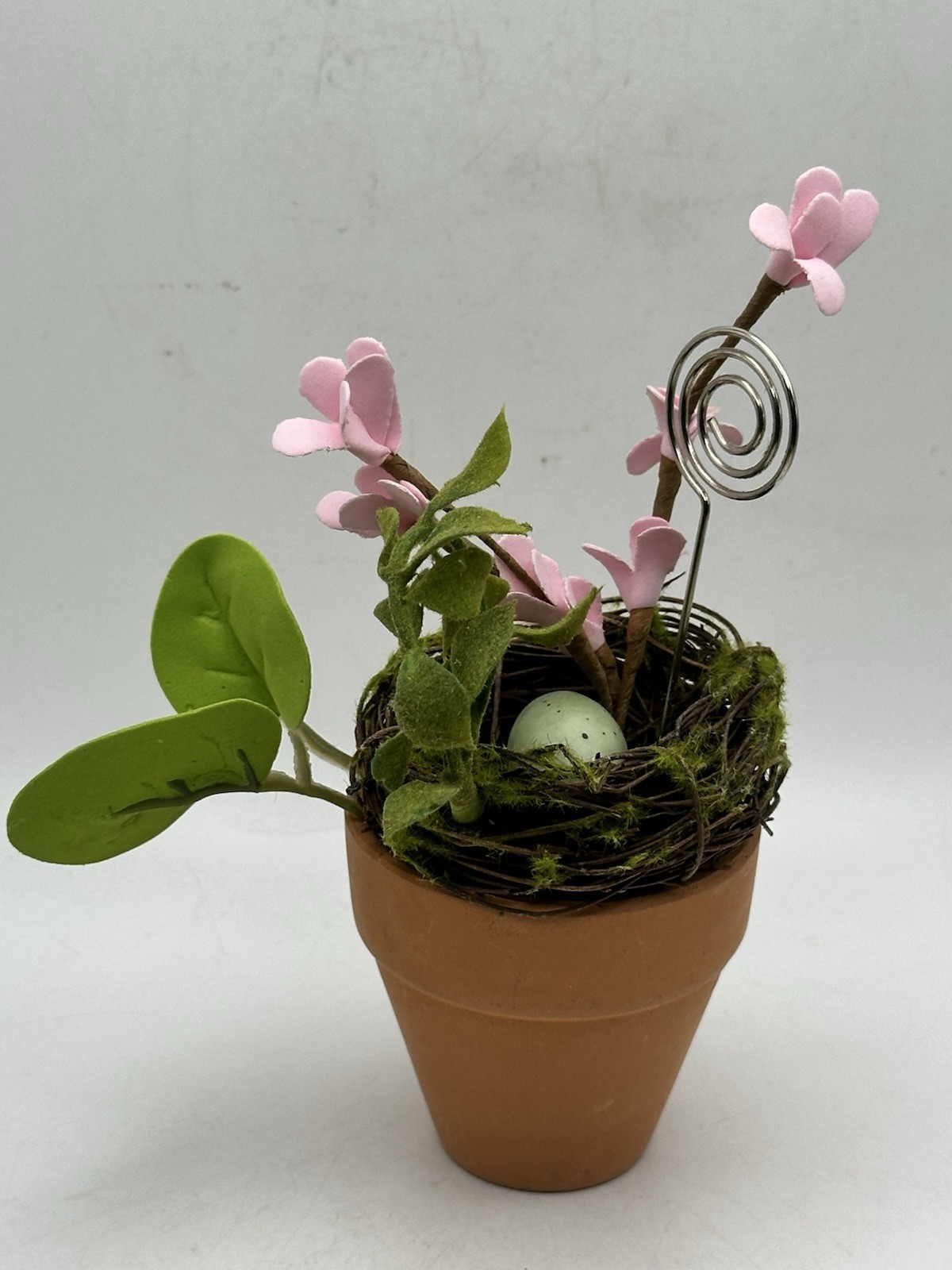 Photo Holder In Spring Themed Pot With Birds Nest Egg Flowers And Foliage