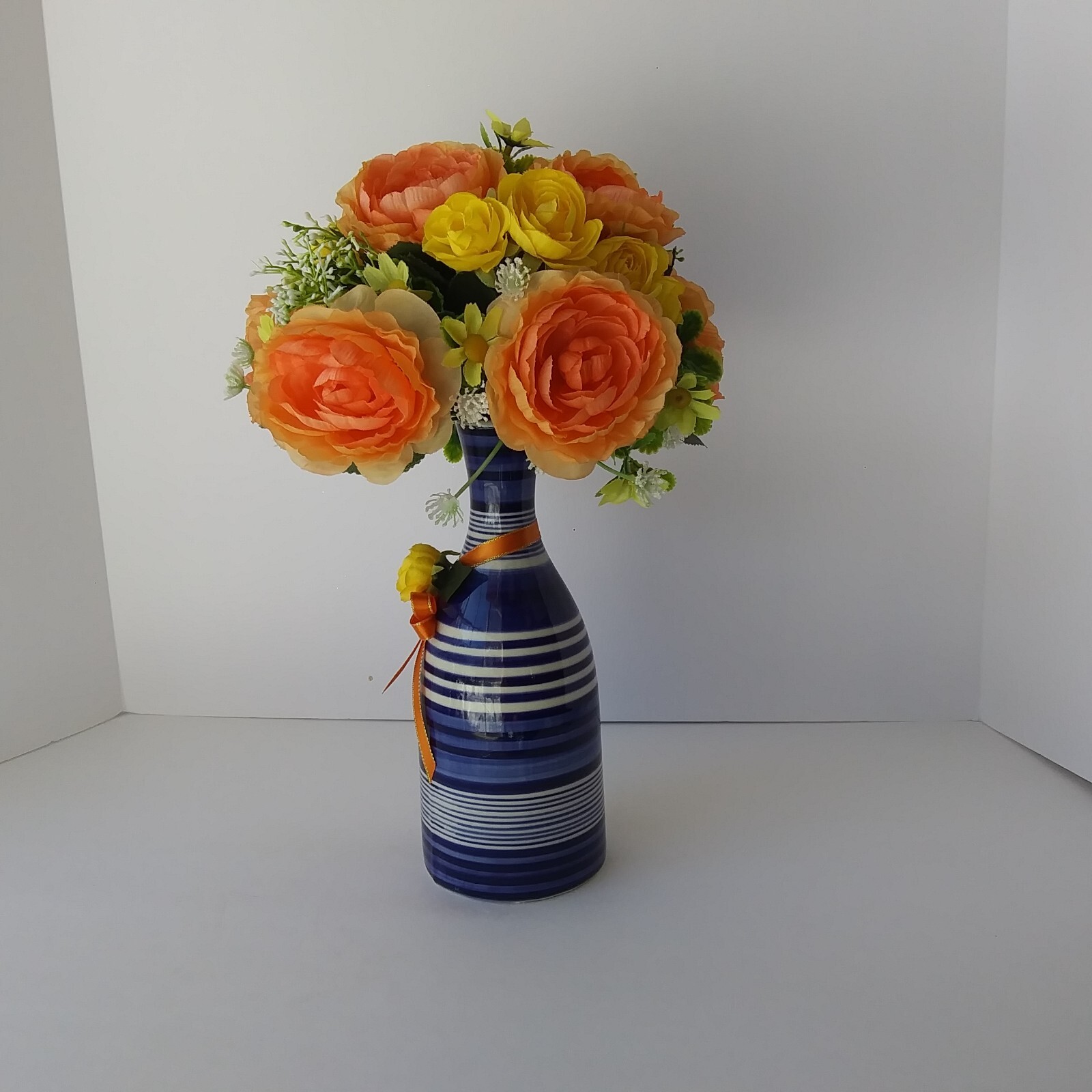 Blue White Striped Pottery Vase with Peach and Yellow Rose Floral Arrangement