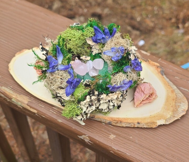 Spring Decor. Bird Nest With Moss Dried Flowers And Crystals. Resting On Wood.