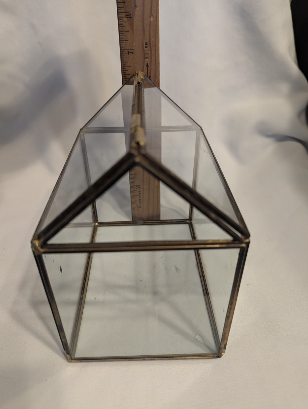 Small house shaped metal and glass terrarium