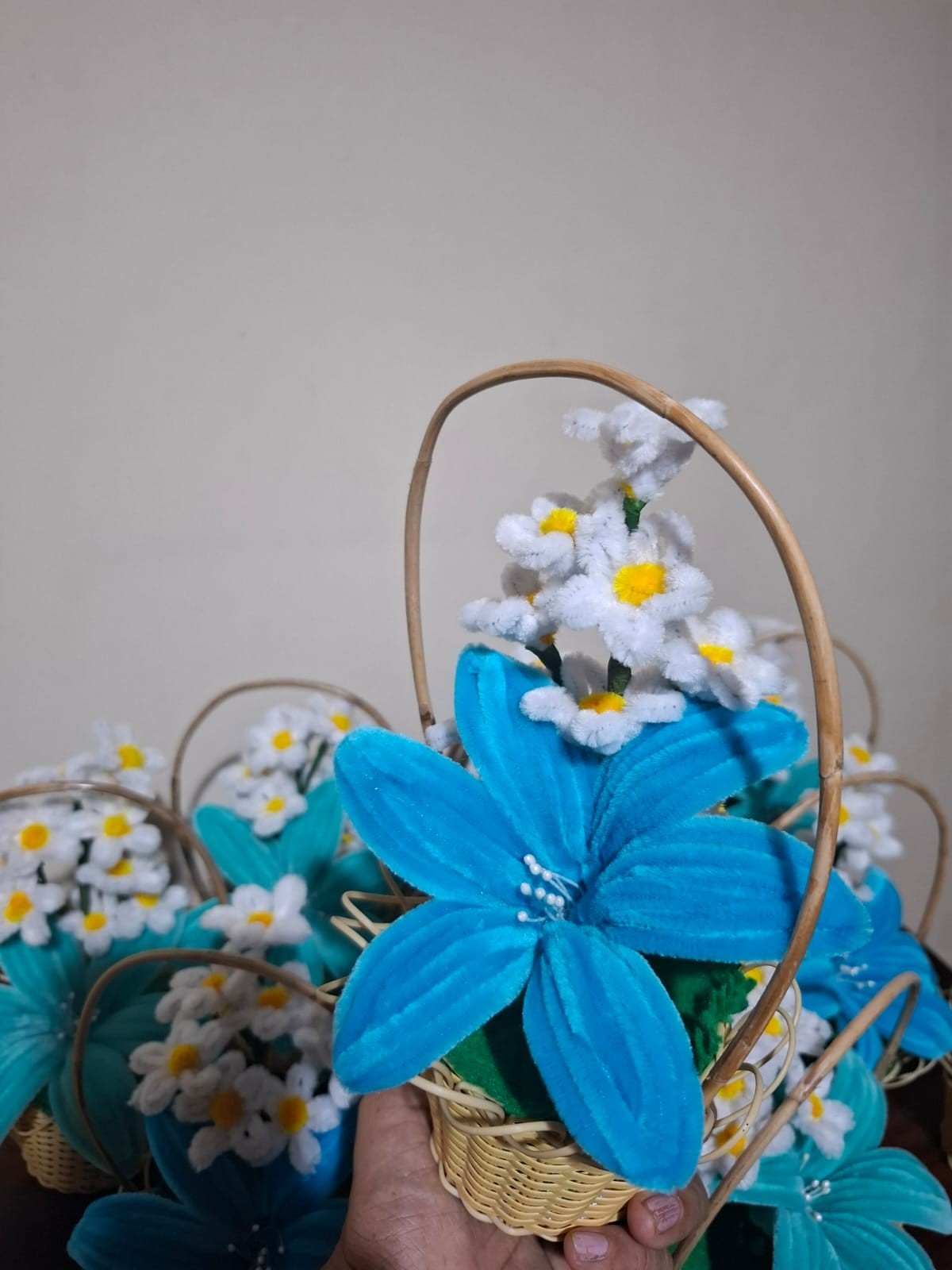 pipe cleaner blue lily flower in a cane basket