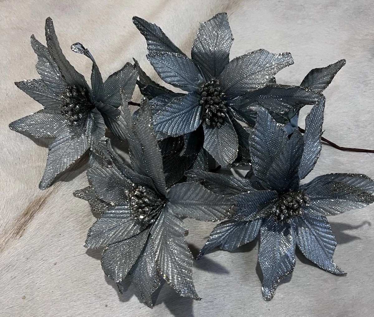 poinsettia flowers in a metallic Blue & silver used as decorations for Christmas