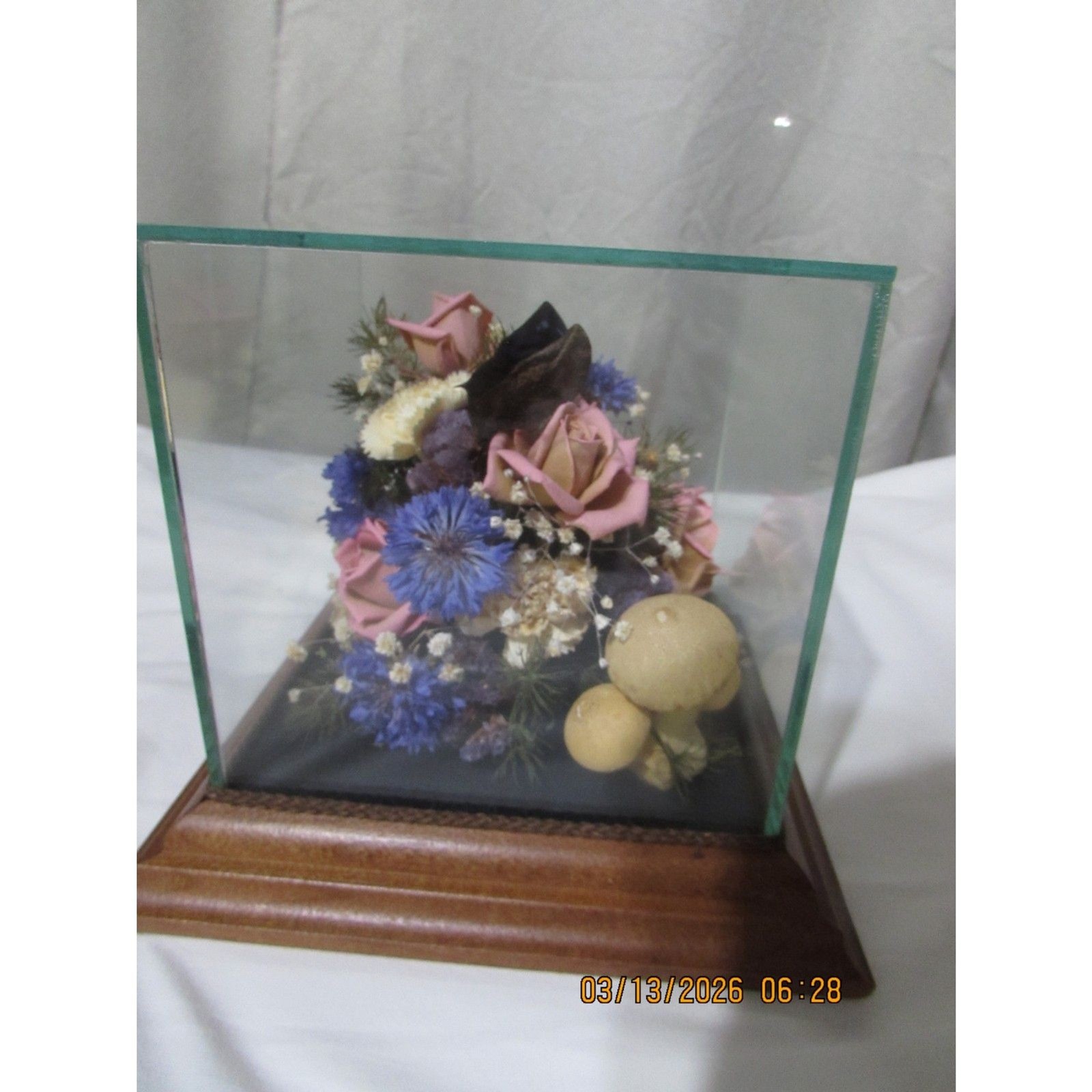Vintage dried flower arrangement in glass with wood base butterfly mushrooms