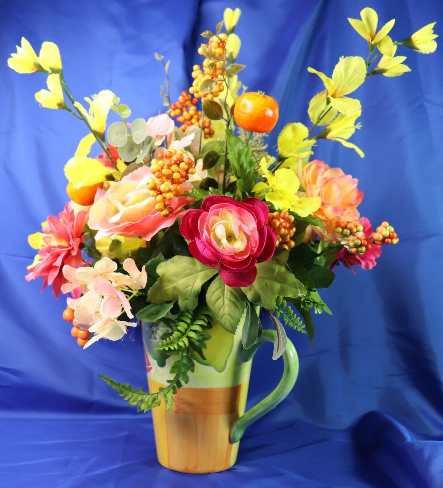 Very Colorful Floral Arrangement In A Beautiful Pitcher With Limes & Oranges
