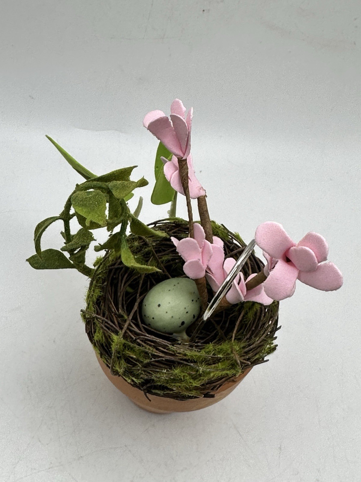 Photo Holder In Spring Themed Pot With Birds Nest Egg Flowers And Foliage