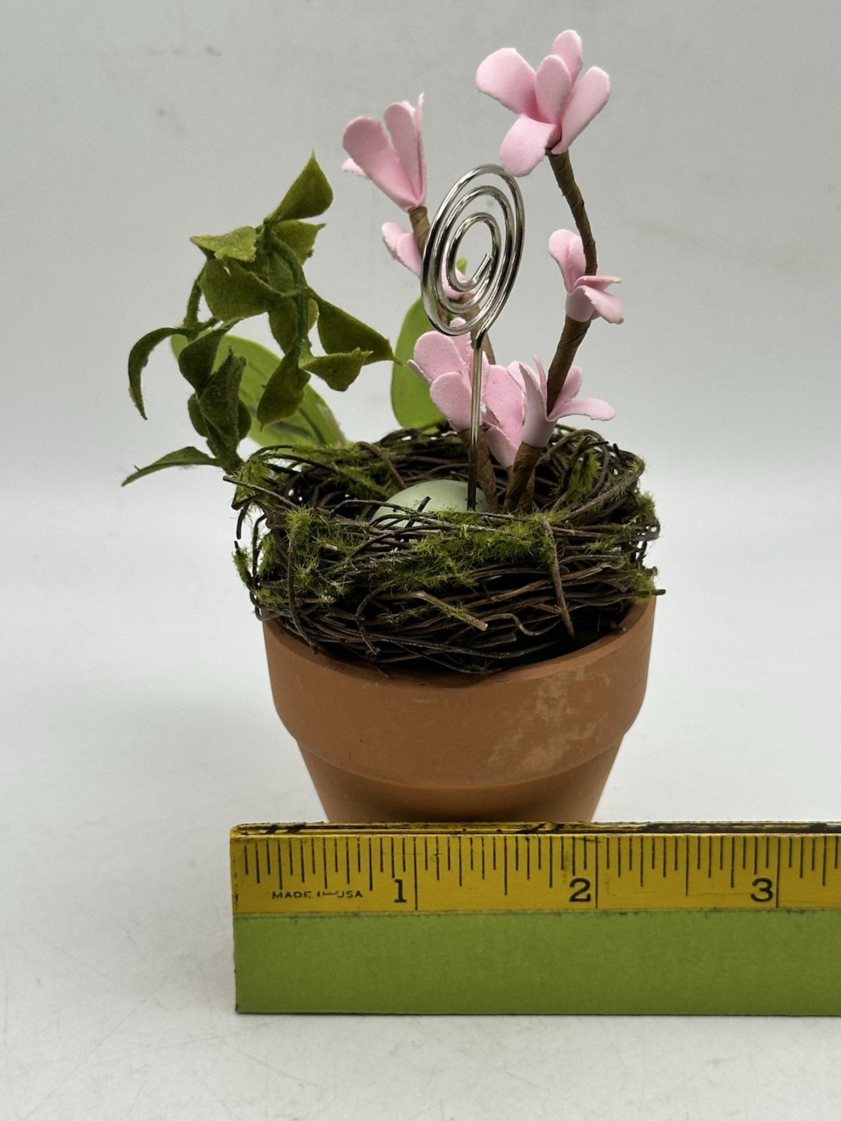 Photo Holder In Spring Themed Pot With Birds Nest Egg Flowers And Foliage