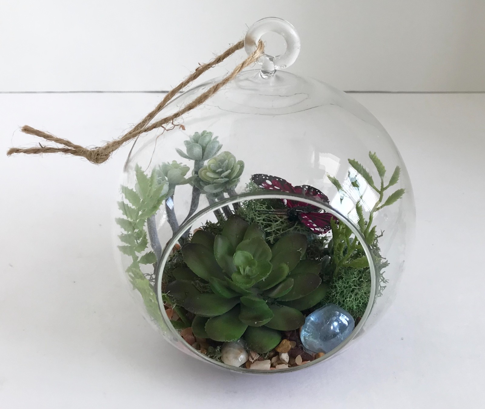 Hanging Round Glass Vase with Artificial Green Grass Succulents and a Purple But