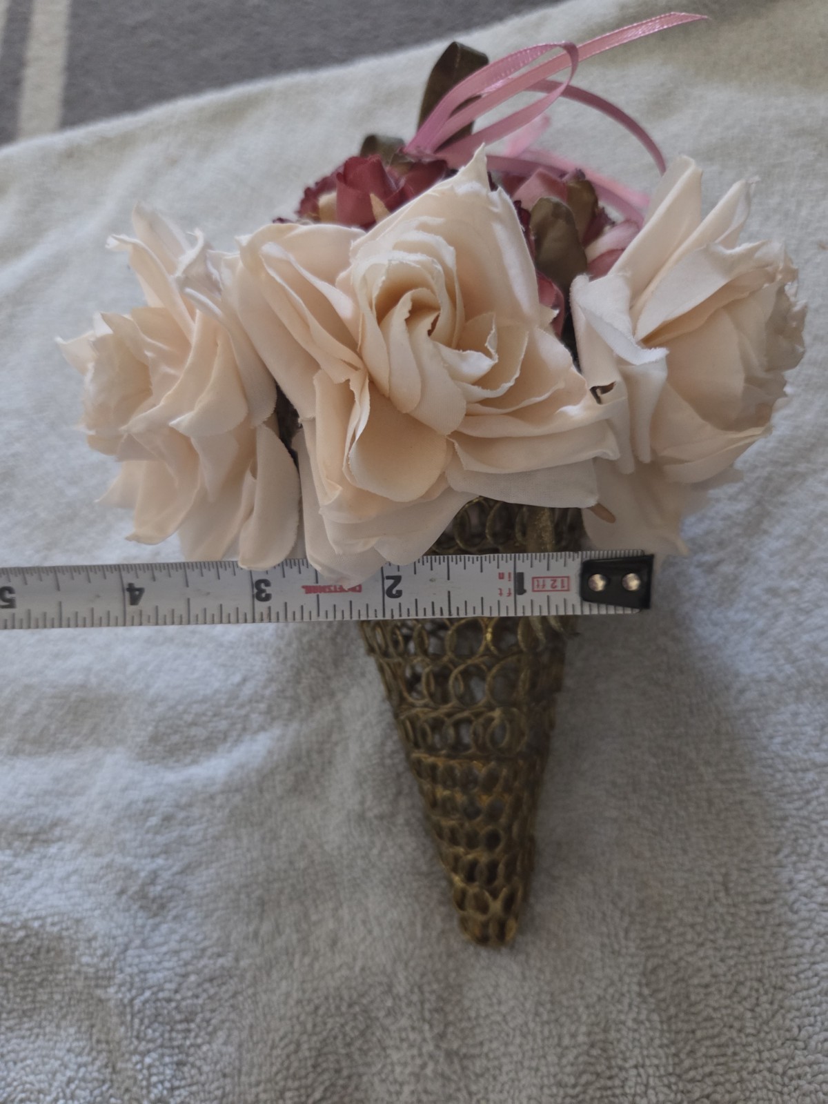 decorative artificial flower arrangement featuring cream and maroon roses