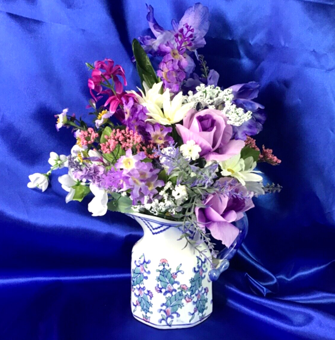 Beautiful Leaf Design Ceramic Pitcher with a Multicolor Floral Arrangement