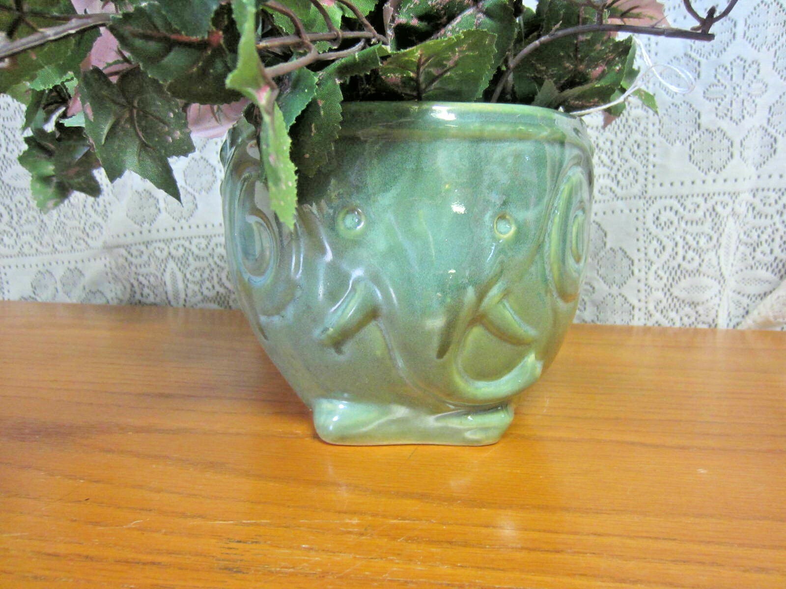 Green Elephant Planter With Green Foliage and Small Orange Flowers