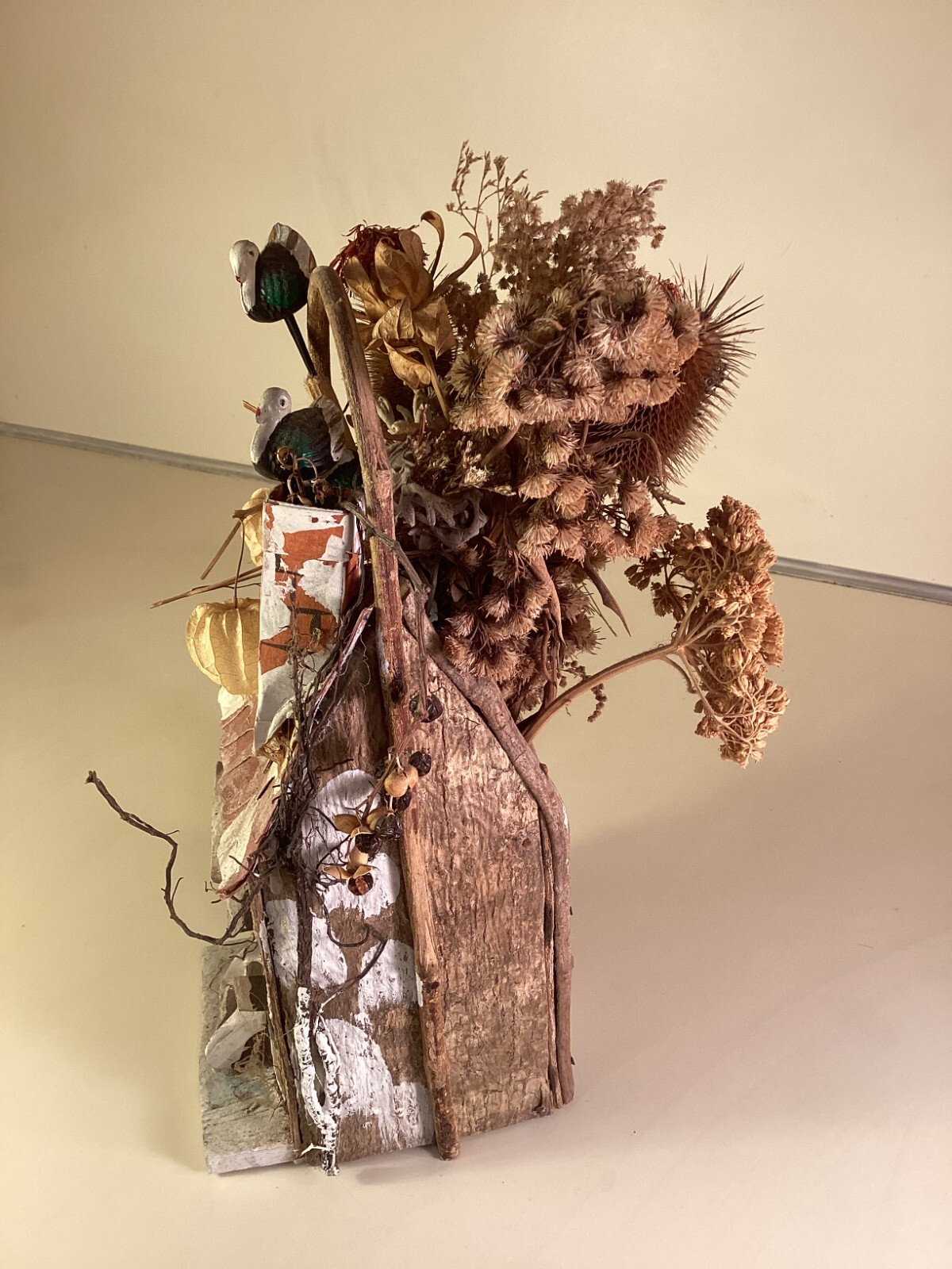 Wood birdhouse centerpiece with dried flowers, turkeys, twigs, windows, chimney