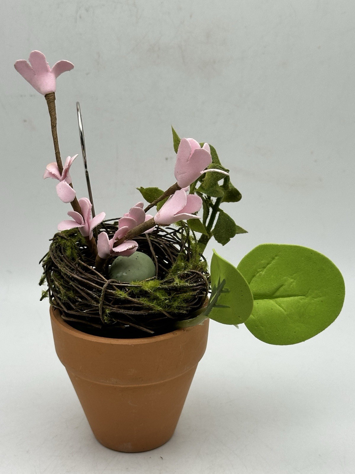 Photo Holder In Spring Themed Pot With Birds Nest Egg Flowers And Foliage