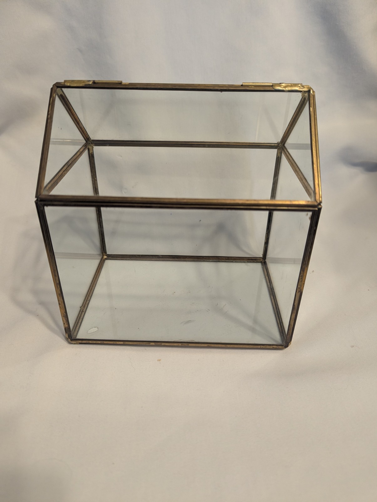 Small house shaped metal and glass terrarium