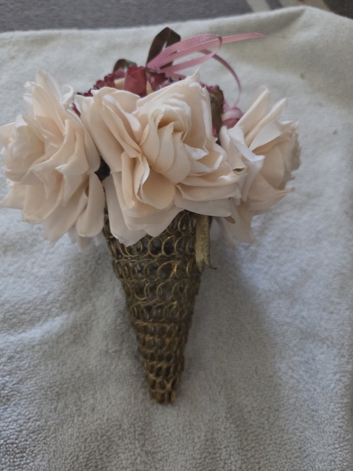 decorative artificial flower arrangement featuring cream and maroon roses