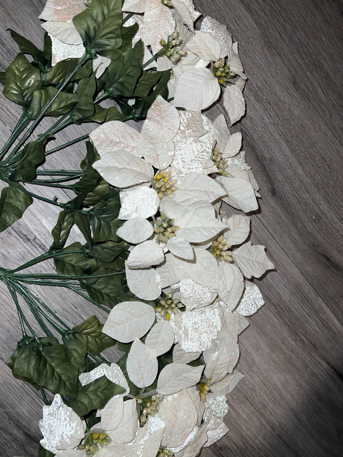 2 artificial white poinsettia bushes with green leaves and sparkle details