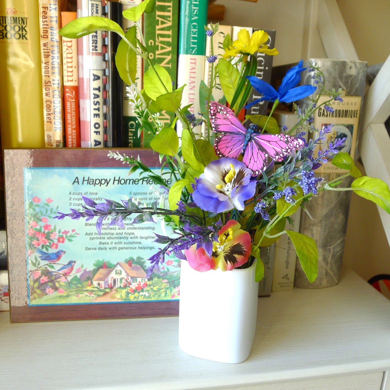 Wildflower Pansy Floral Arrangement Pink Feather Butterfly and a White Planter