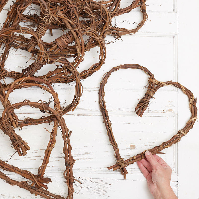 Bulk Package of 12 Natural Grapevine 12″ Heart Wreaths