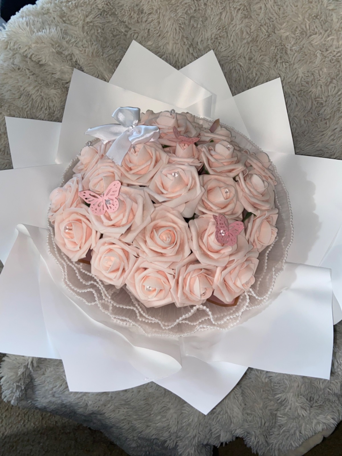 Pink flower bouquet made with 25 artificial flowers.
