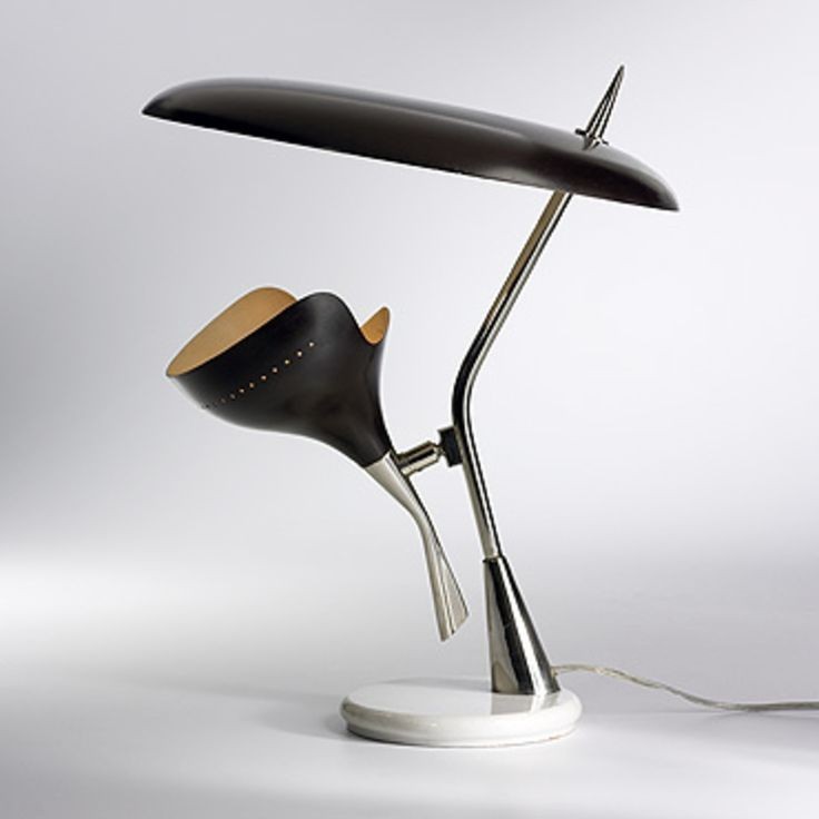 This is a very unique and stylish table lamp with a modern, sculptural design.