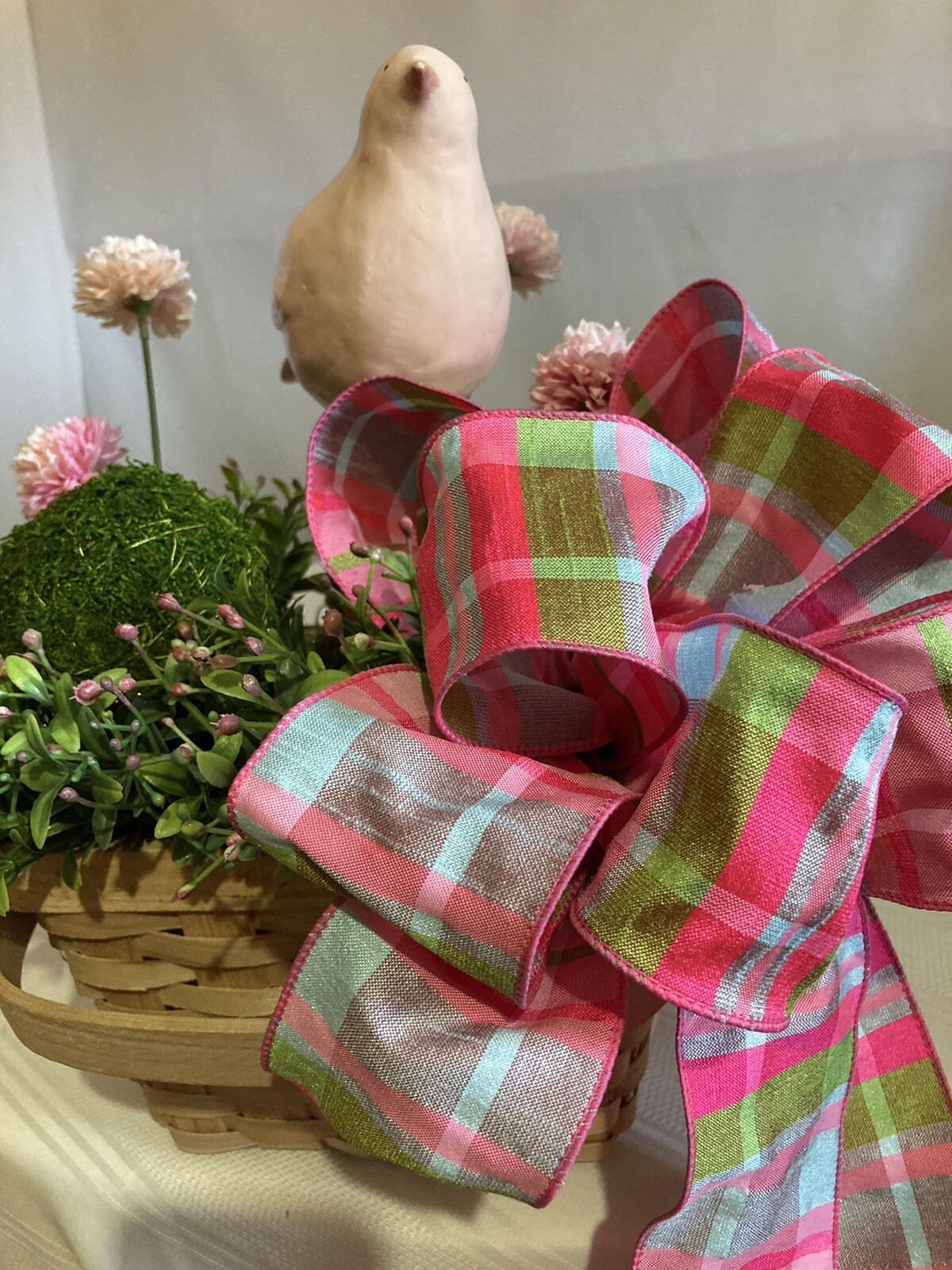 Delightful Pink Bird Surrounded In Boxwood Greenery In A Basket
