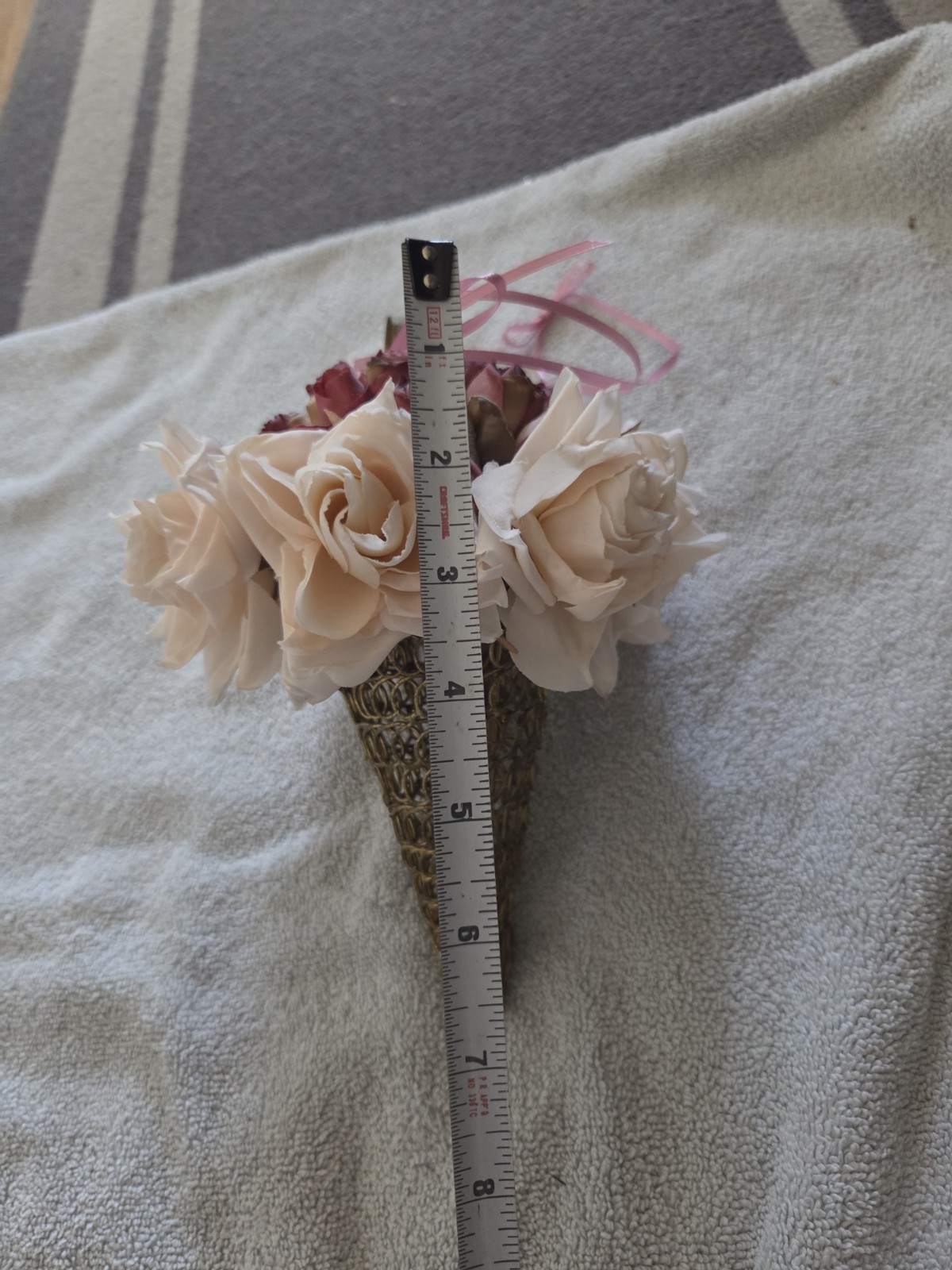 decorative artificial flower arrangement featuring cream and maroon roses