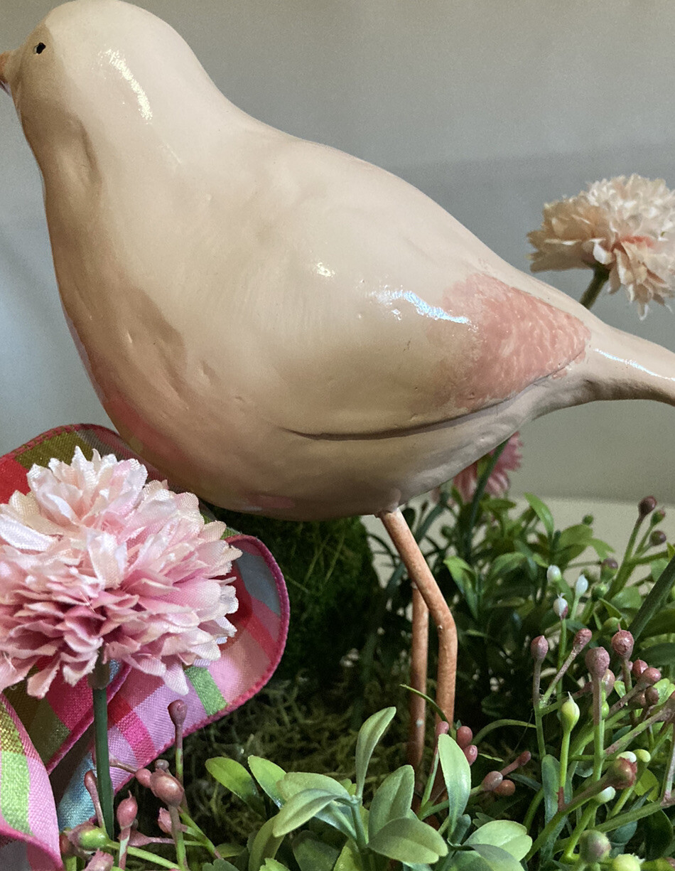Delightful Pink Bird Surrounded In Boxwood Greenery In A Basket